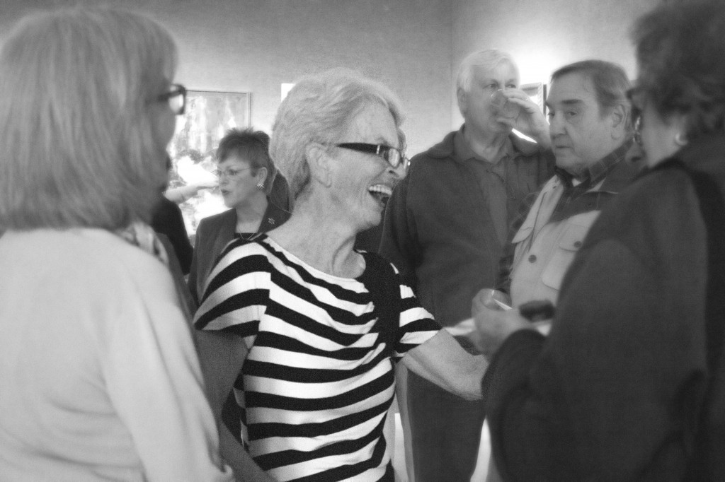 Sally Peek greets family and friends at art show reception featuring over 70 pieces of art.